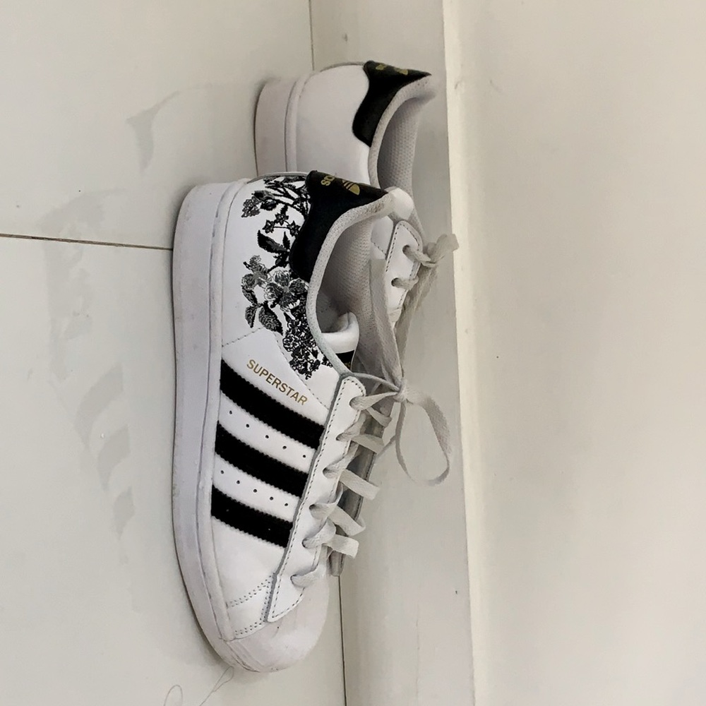 black adidas with a floral print